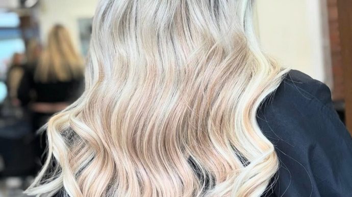 Pearl blonde hair in loose curls, seen from behind.